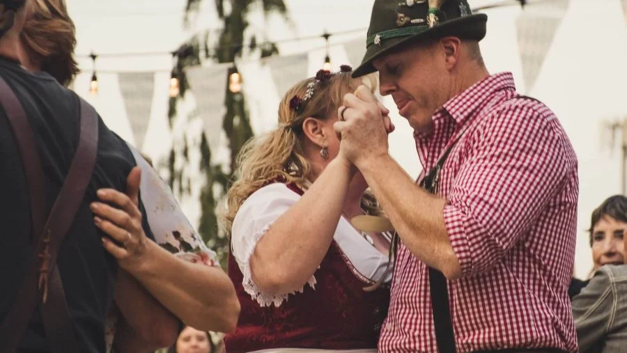 a-couple-dancing-in-traditional-german-attire-at-the-vail-oktoberfest
